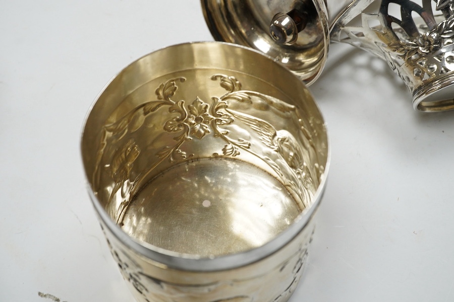 An Edwardian silver 'Reynold's Angels' silver canister, William Comyns, London, 1902, 90mm, together with a silver table perpetual lighter, silver bonbon basket and silver ring box. Condition - poor to fair